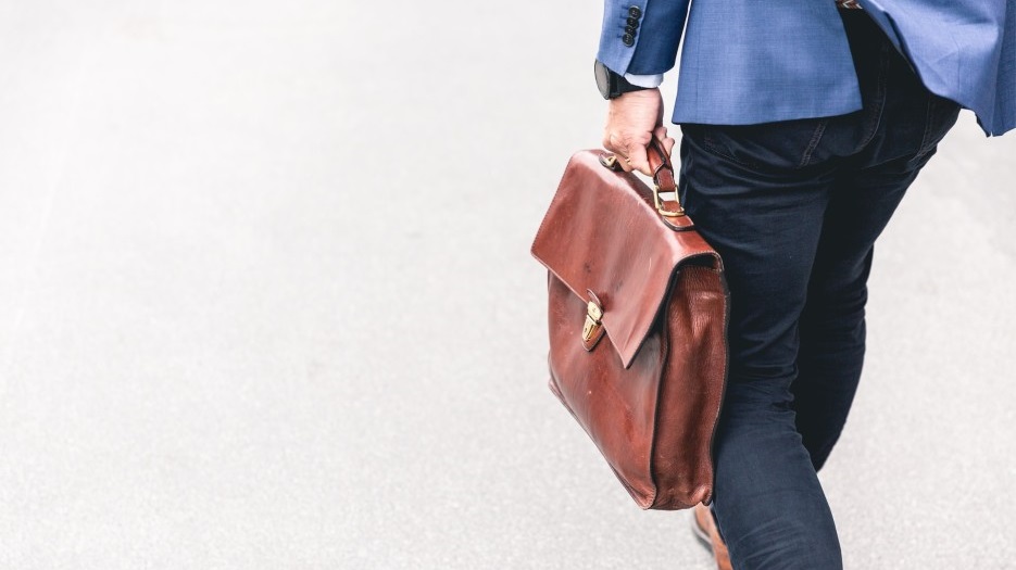 professionally dressed business person in Vietnam holding a suitcase